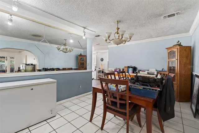 a kitchen with a table and chairs in it