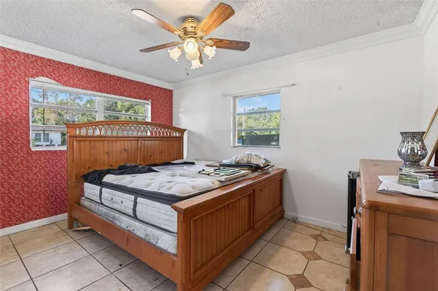 a bedroom with a stove and a chandelier