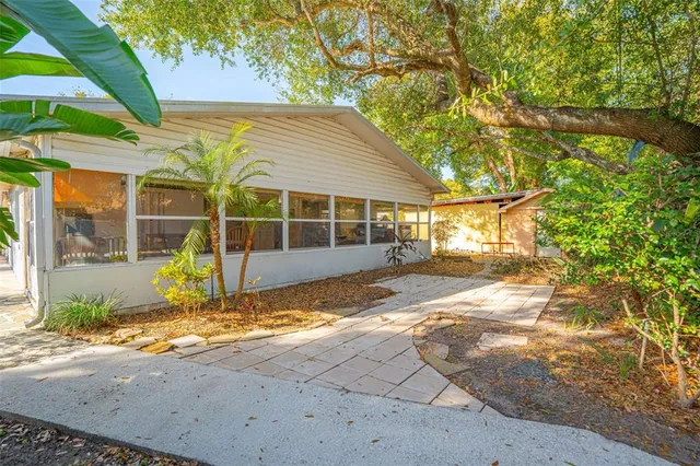 a view of a house with backyard and sitting area