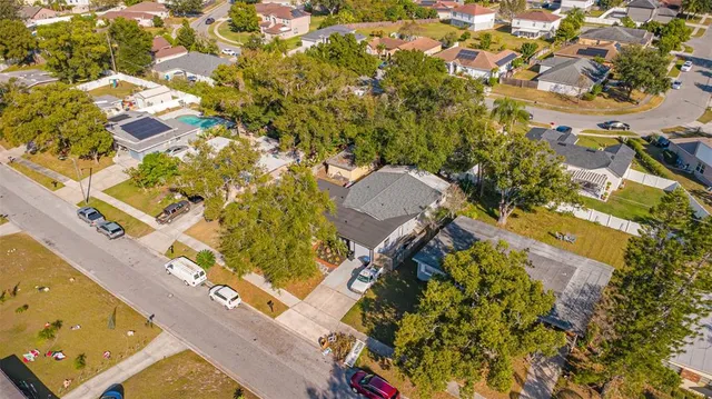 an aerial view of residential houses with yard