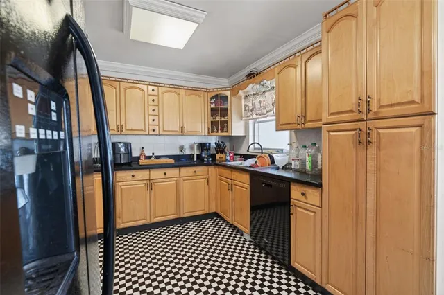 a kitchen with a sink a window and cabinets