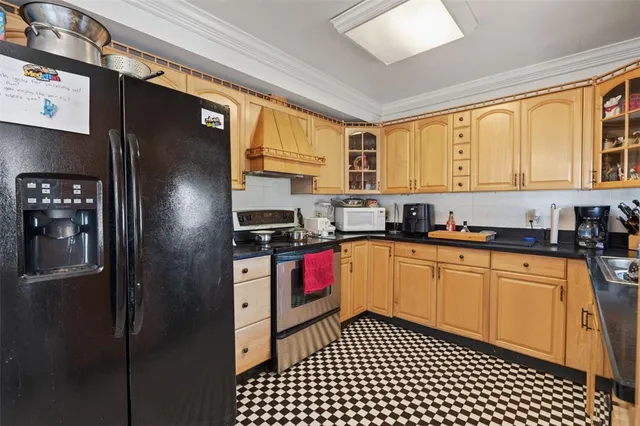 a kitchen with stainless steel appliances granite countertop a refrigerator and a sink