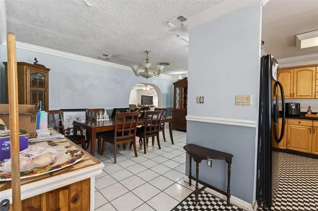 a kitchen with stainless steel appliances granite countertop a stove top oven a sink a dining table and chairs with wooden floor