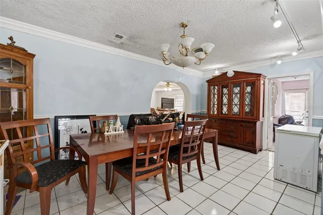 a view of a dining room with furniture and a chandelier