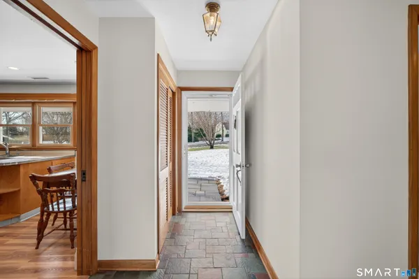 a view of a hallway with dining area and chandelier