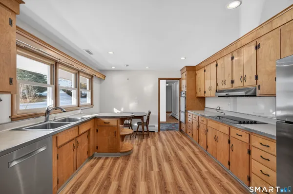 a kitchen with stainless steel appliances a sink stove and cabinets