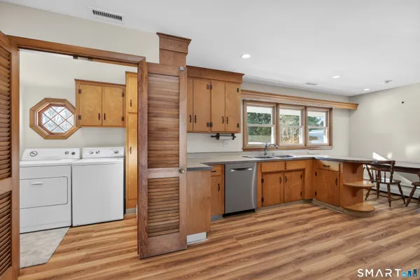 a kitchen with a refrigerator stove and wooden cabinets