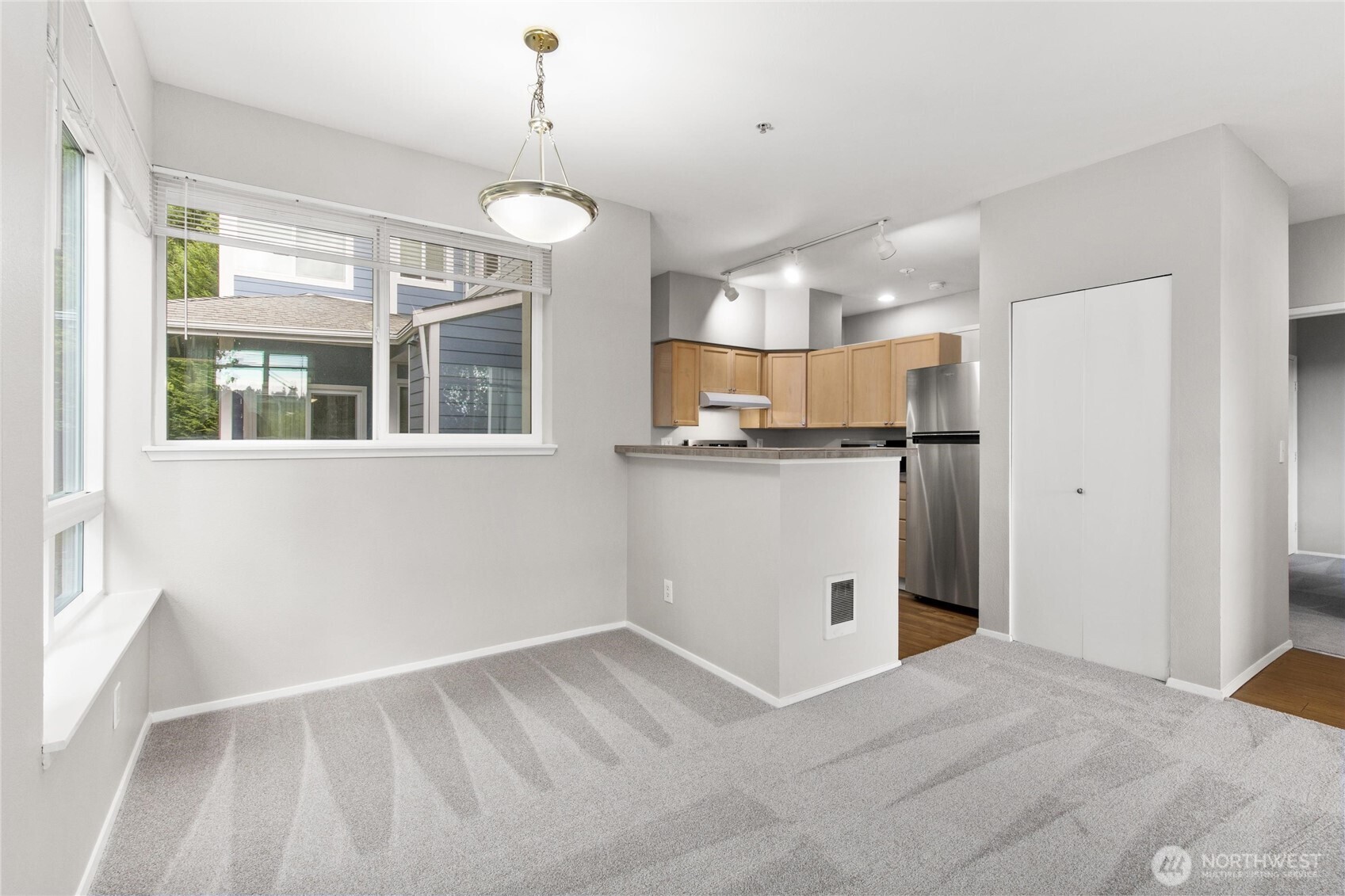 3926 243rd Place Southeast, Unit H201 Bothell, WA 98021 - Photo 11 of 31 a view of a kitchen with a sink stove cabinets and wooden floor