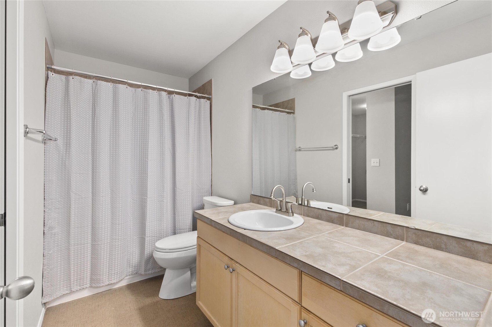 3926 243rd Place Southeast, Unit H201 Bothell, WA 98021 - Photo 16 of 31 a bathroom with a double vanity sink mirror and toilet