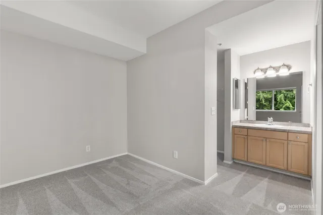 a front view of a house with a yard and potted plants