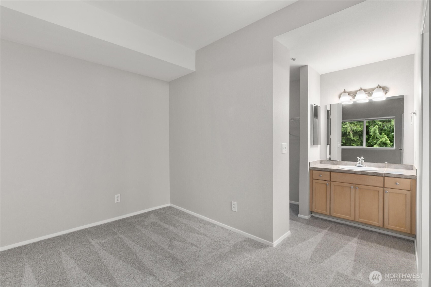 3926 243rd Place Southeast, Unit H201 Bothell, WA 98021 - Photo 22 of 31 a bathroom with a granite countertop sink and a mirror