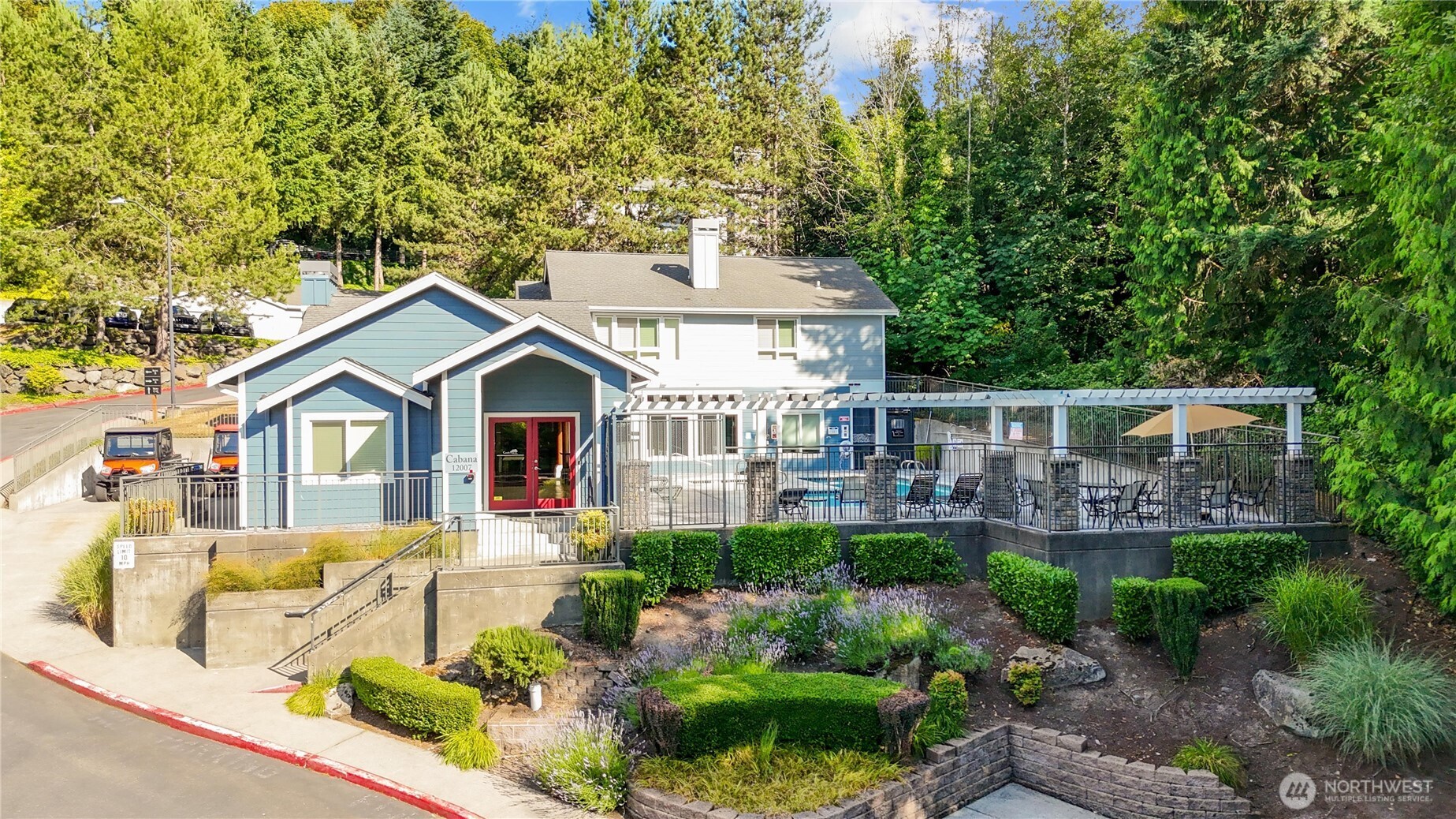 3926 243rd Place Southeast, Unit H201 Bothell, WA 98021 - Photo 23 of 31 a front view of a house with a yard and potted plants