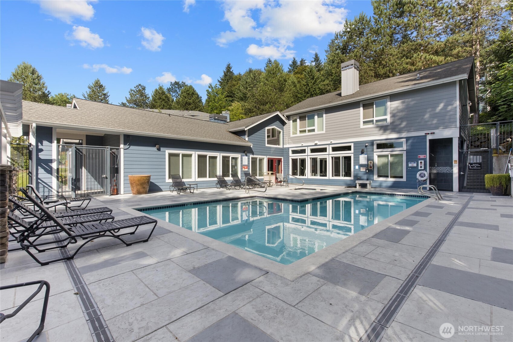 3926 243rd Place Southeast, Unit H201 Bothell, WA 98021 - Photo 25 of 31 a view of a house with pool and chairs