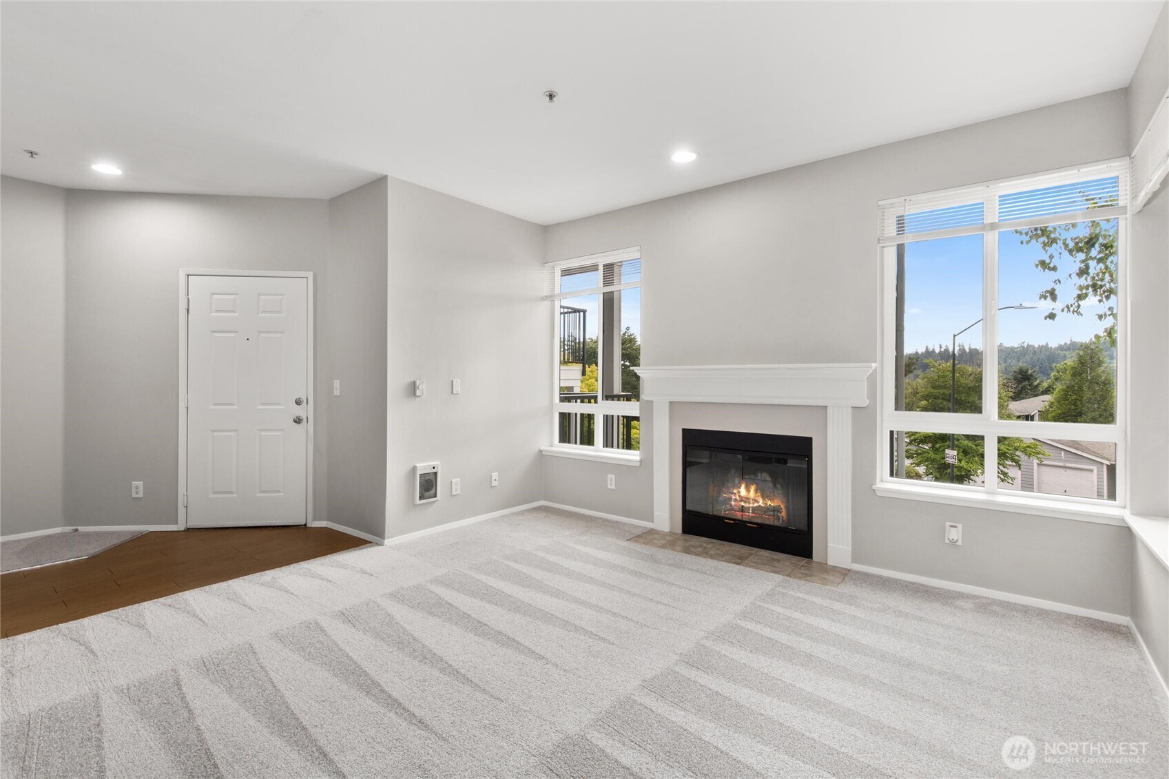 3926 243rd Place Southeast, Unit H201 Bothell, WA 98021 - Photo 4 of 31 a bedroom with a bed and a fireplace