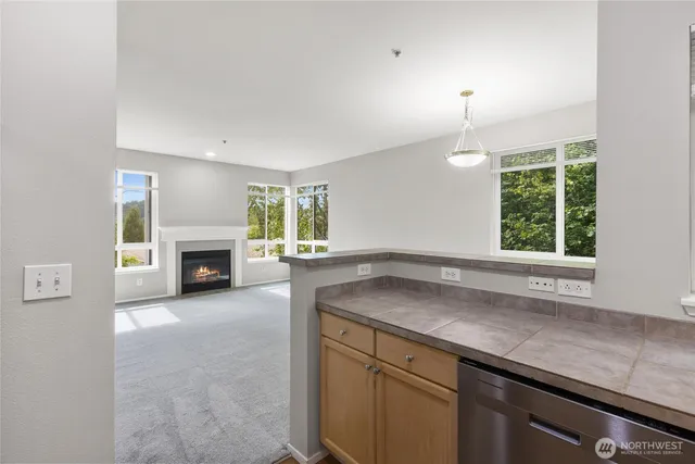 a view of a kitchen with a sink stove cabinets and wooden floor