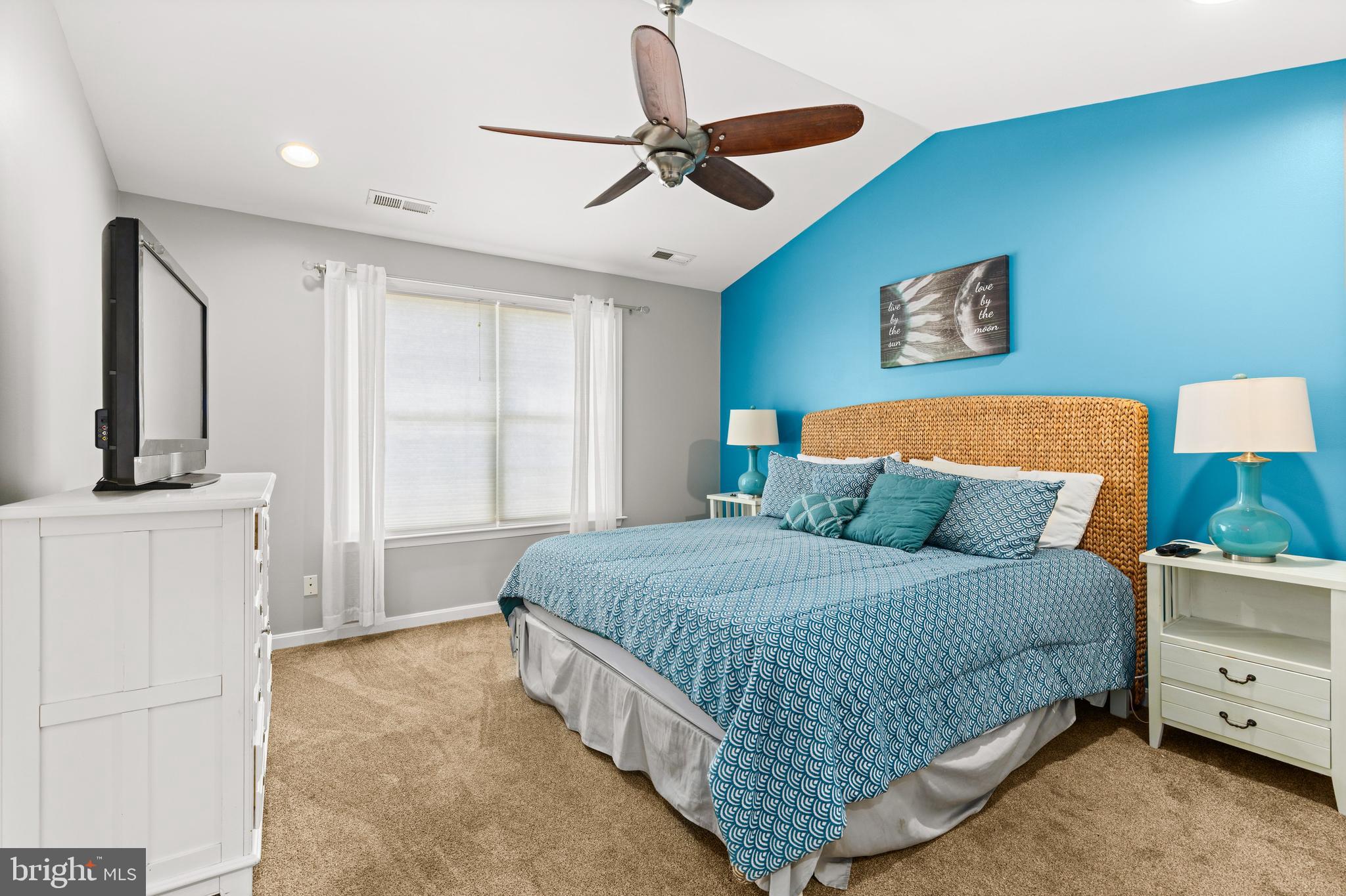 617 Salt Spray Road, Unit B Ocean City, MD 21842 - Photo 37 of 72 a bedroom with a bed and a dresser