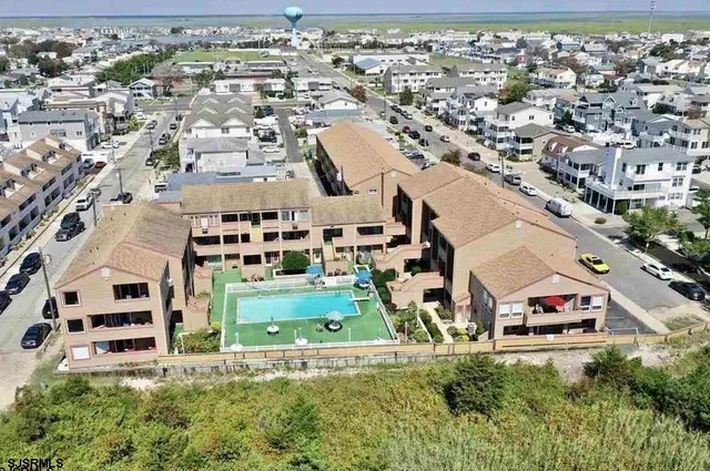 an aerial view of residential houses with outdoor space