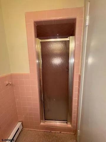 a bathroom with a glass door shower