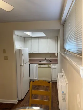 a kitchen with a refrigerator and a stove