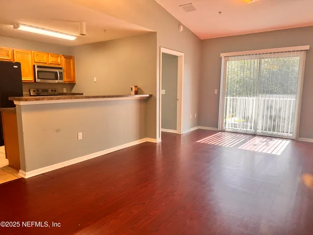 a view of a livingroom with wooden floor
