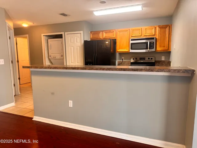 a view of kitchen with wooden floor