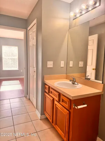 a bathroom with a sink a vanity and a mirror