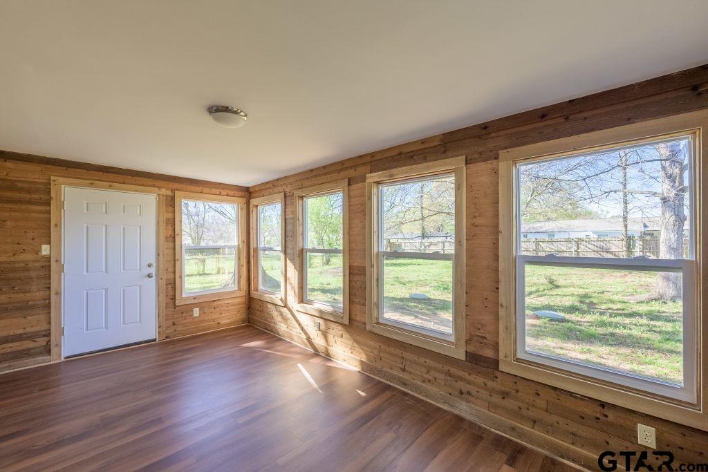 14212 Arber Street Flint, TX 75762 - Photo 19 of 38 a view of an empty room with wooden floor and a window