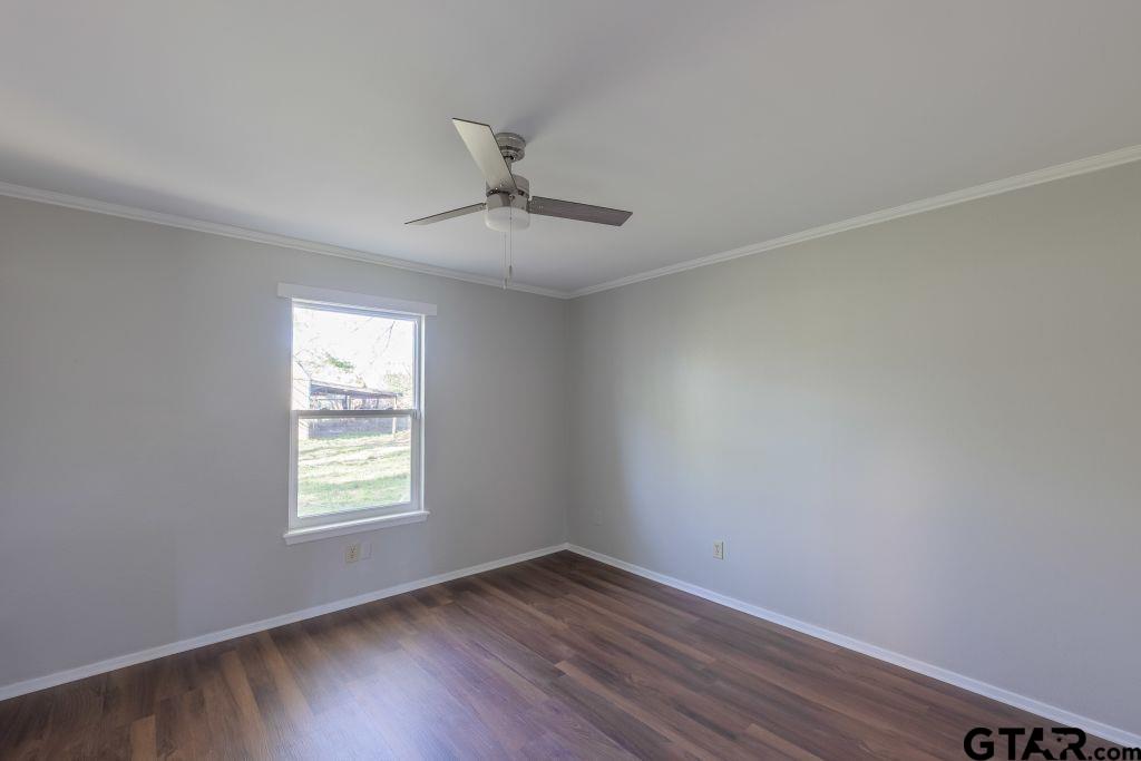 14212 Arber Street Flint, TX 75762 - Photo 23 of 38 an empty room with wooden floor and windows