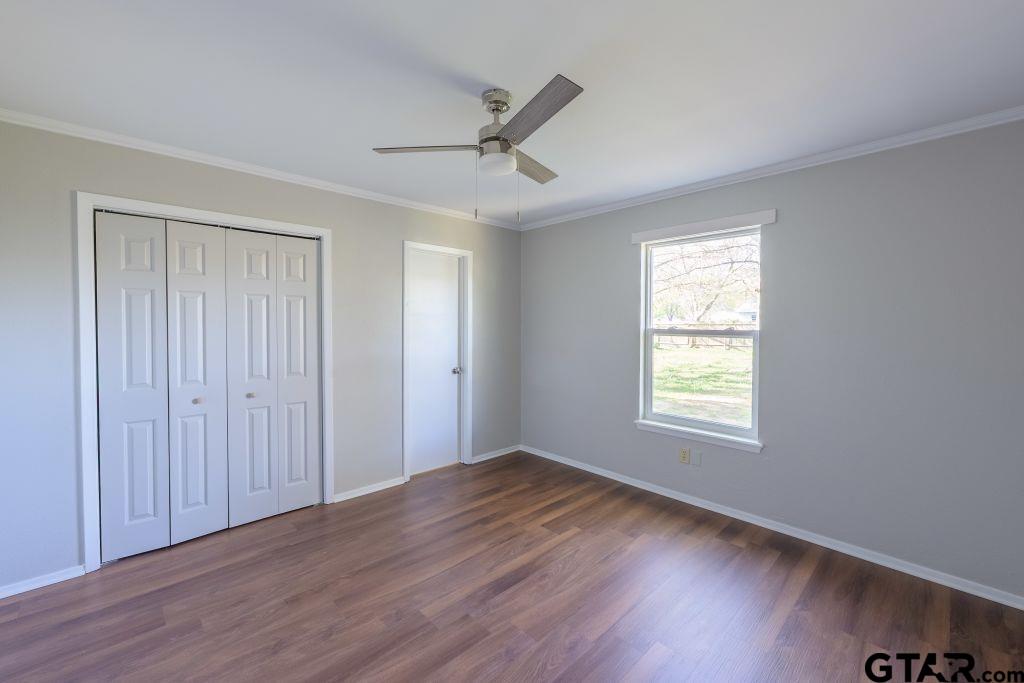 14212 Arber Street Flint, TX 75762 - Photo 24 of 38 a view of an empty room with wooden floor and a window