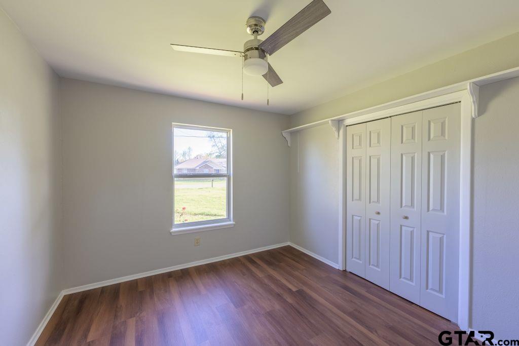 14212 Arber Street Flint, TX 75762 - Photo 30 of 38 a view of an empty room with wooden floor and a window