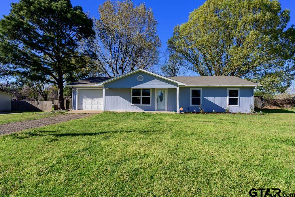 14212 Arber Street Flint, TX 75762 - Photo 3 of 38 a view of a house with a big yard potted plants and large tree