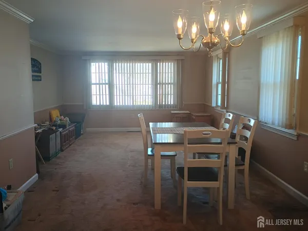 a view of a dining room with furniture and chandelier