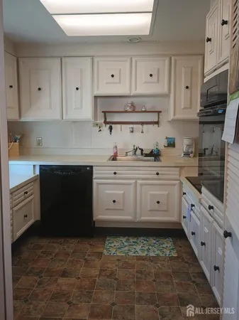 a kitchen with stainless steel appliances a stove a sink and a refrigerator
