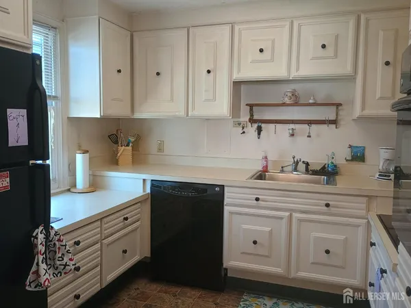 a kitchen with stainless steel appliances white cabinets and a sink