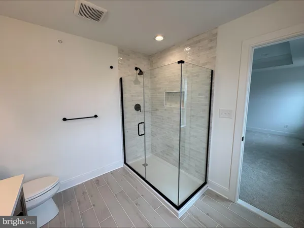 a bathroom with a shower and toilet