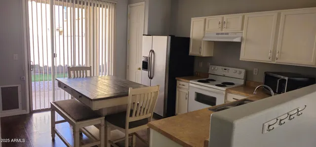 a kitchen with cabinets and refrigerator
