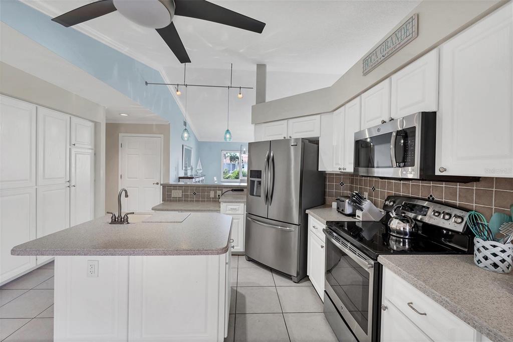 11 Amberjack Terrace Placida, FL 33946 - Photo 11 of 38 a kitchen with stainless steel appliances granite countertop a sink stove and refrigerator