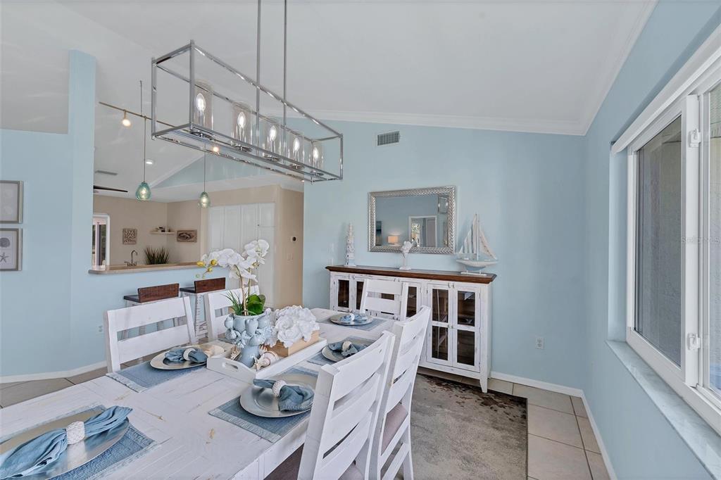 11 Amberjack Terrace Placida, FL 33946 - Photo 13 of 38 a view of a dining room with furniture a chandelier and wooden floor