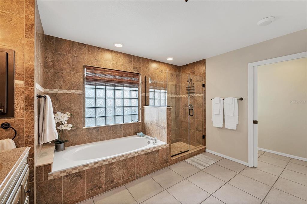 11 Amberjack Terrace Placida, FL 33946 - Photo 19 of 38 a spacious bathroom with a granite countertop bathtub shower and a sink