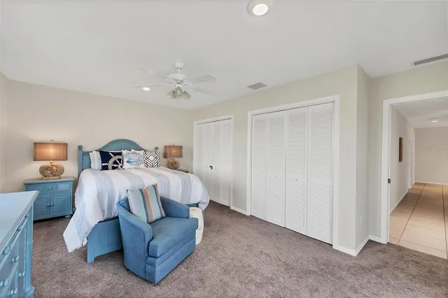 a bedroom with a bed and a lamp