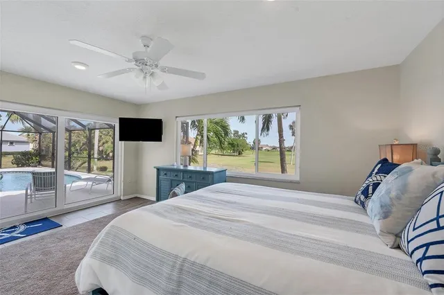 a bedroom with a large bed and a flat tv screen