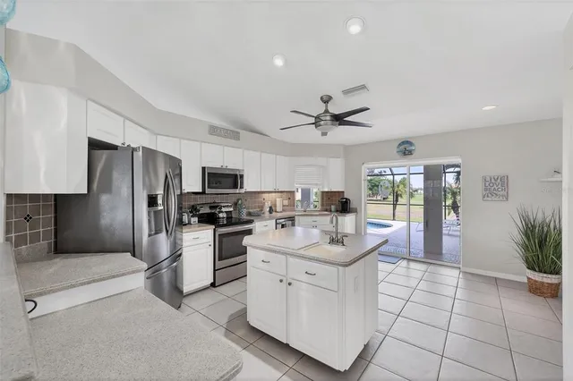 a kitchen with stainless steel appliances a refrigerator sink and microwave