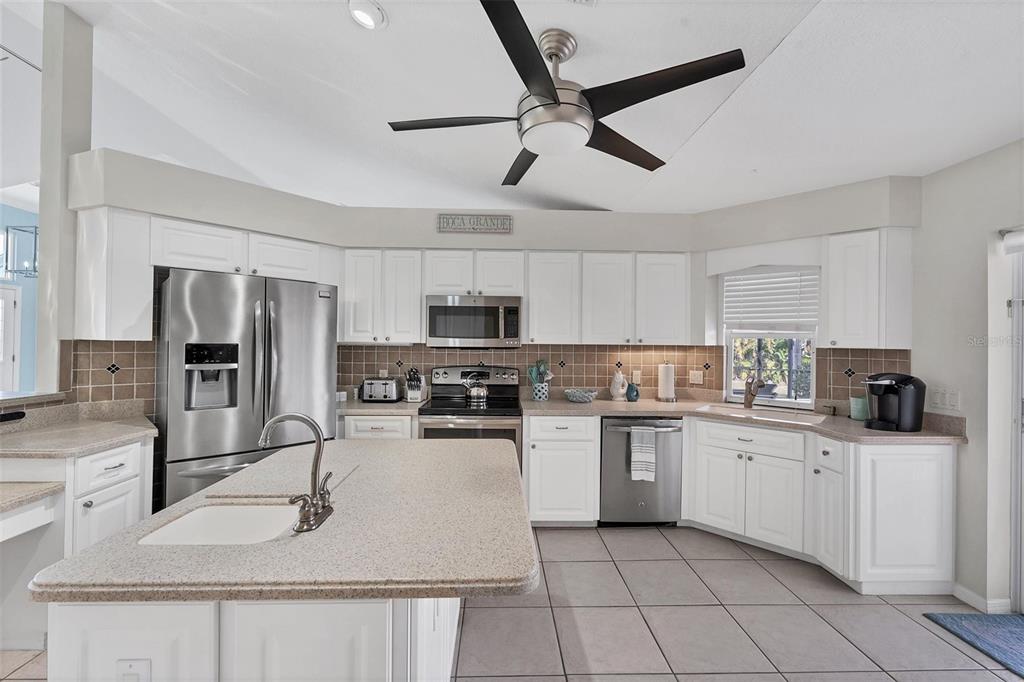11 Amberjack Terrace Placida, FL 33946 - Photo 10 of 38 a kitchen with stainless steel appliances a sink stove refrigerator and cabinets