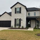 a view of a house with a yard and garage