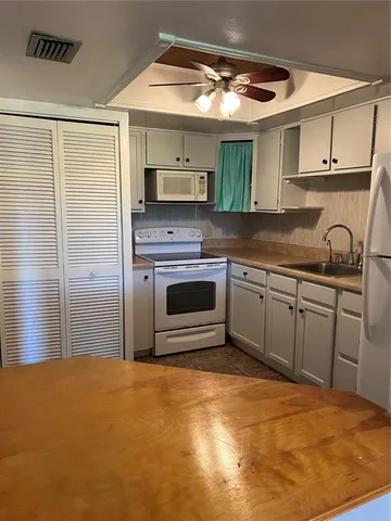 a kitchen with stainless steel appliances granite countertop a sink and cabinets