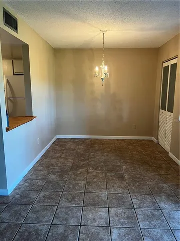 an empty room with a empty space dryer and staircase