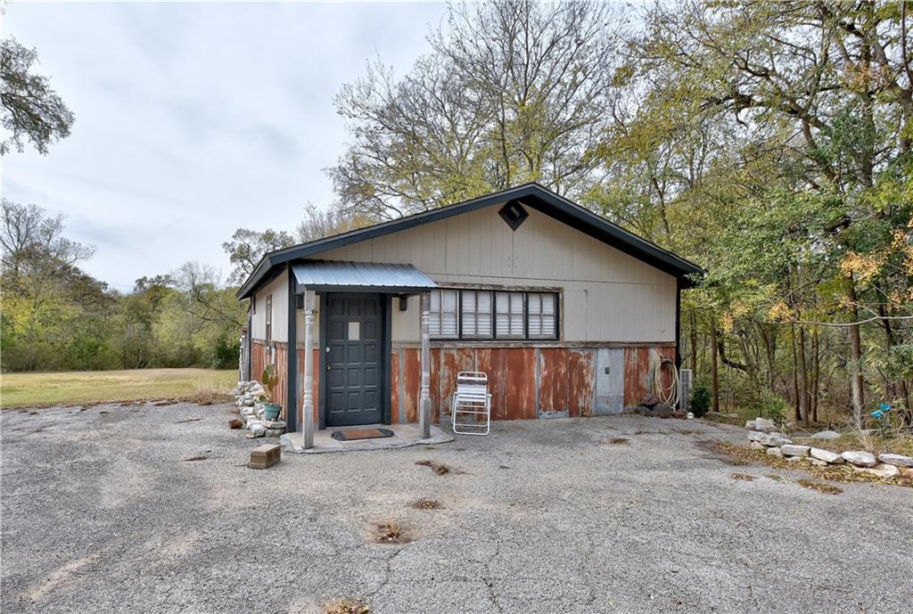 2381 Highway 71 Cedar Creek, TX 78612 - Photo 1 of 16 a view of a house with a yard and large tree