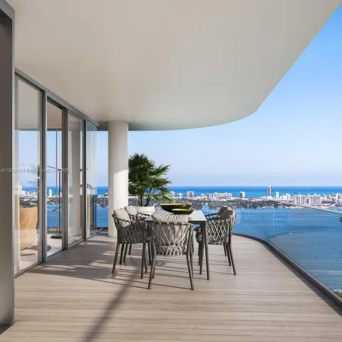 a view of a patio with chairs and table on the wooden floor