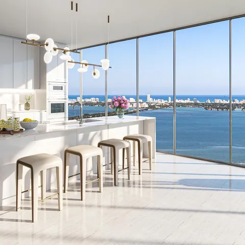a kitchen with granite countertop a table and chairs