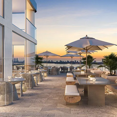 a view of a patio with a dining table and chairs under an umbrella